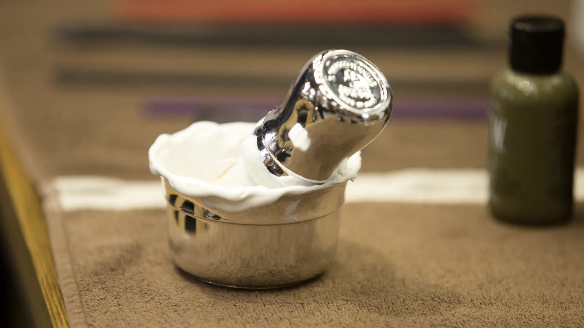 Shaving brush with shaving soap in a shaving bowl